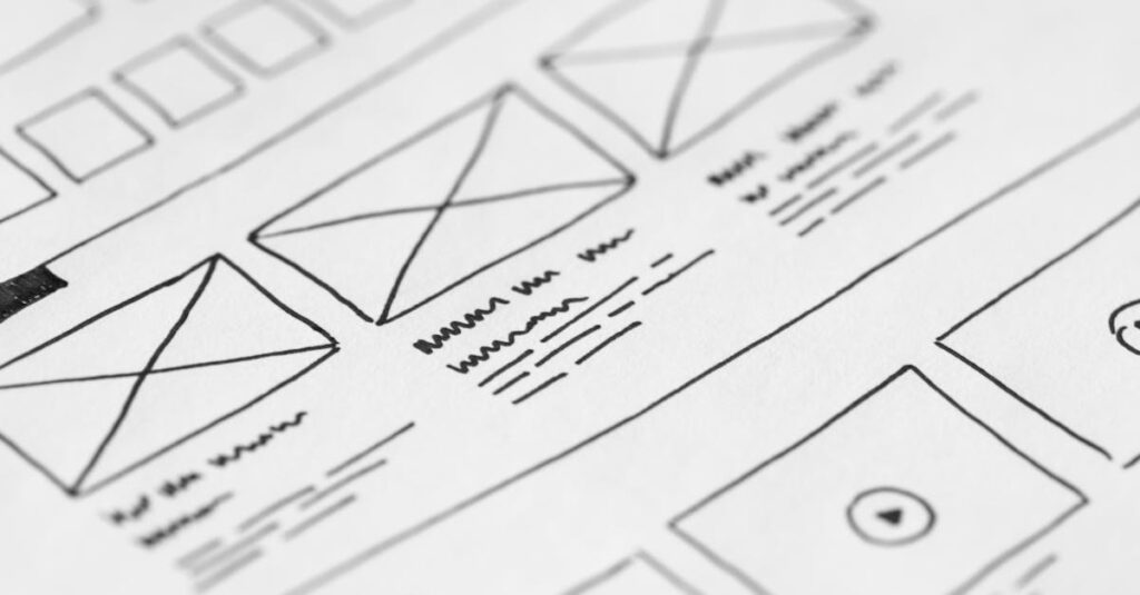 Detailed close-up of a hand-drawn wireframe design on paper for a UX project.